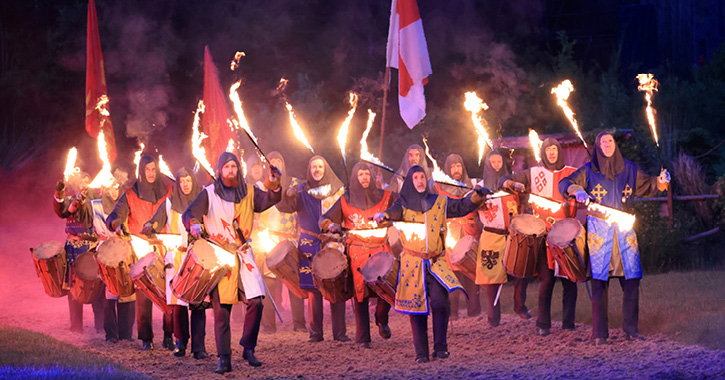 group of knights holding flaming torches at Kynren